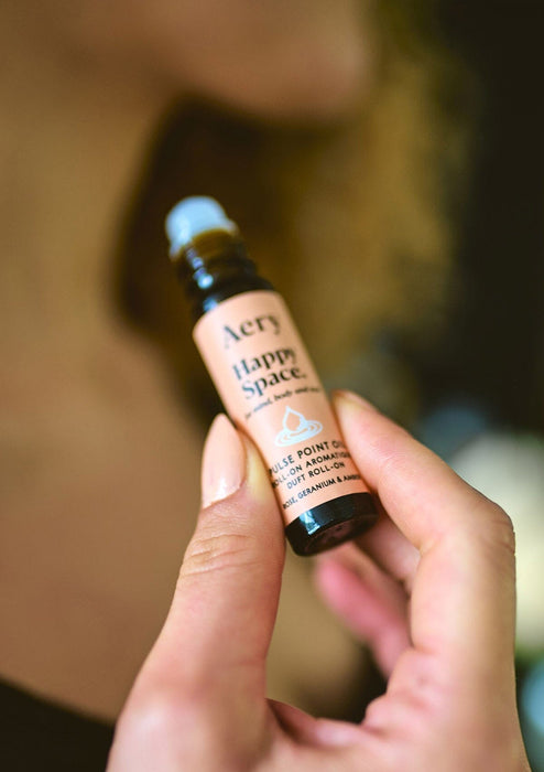 Pink Happy Space pulse point oil by Aery displayed in hands 