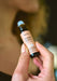 Pink Happy Space pulse point oil by Aery displayed in hands 