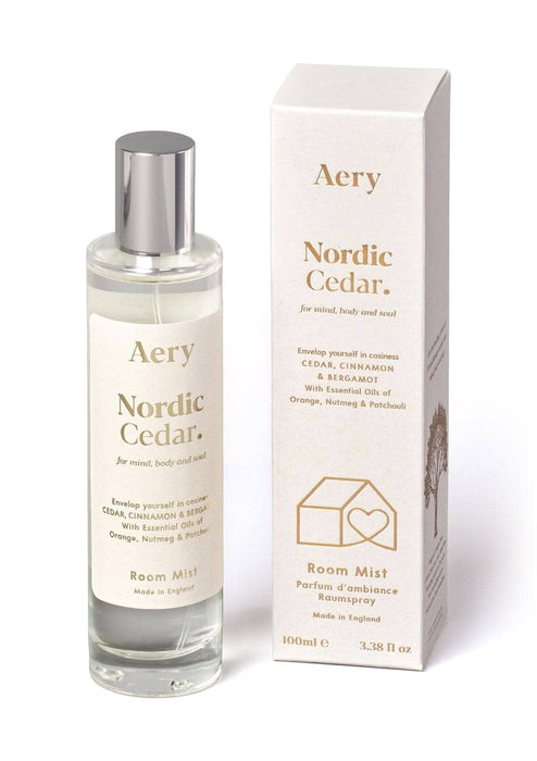 White Nordic Cedar room mist displayed next to product packaging by Aery on white bacground 